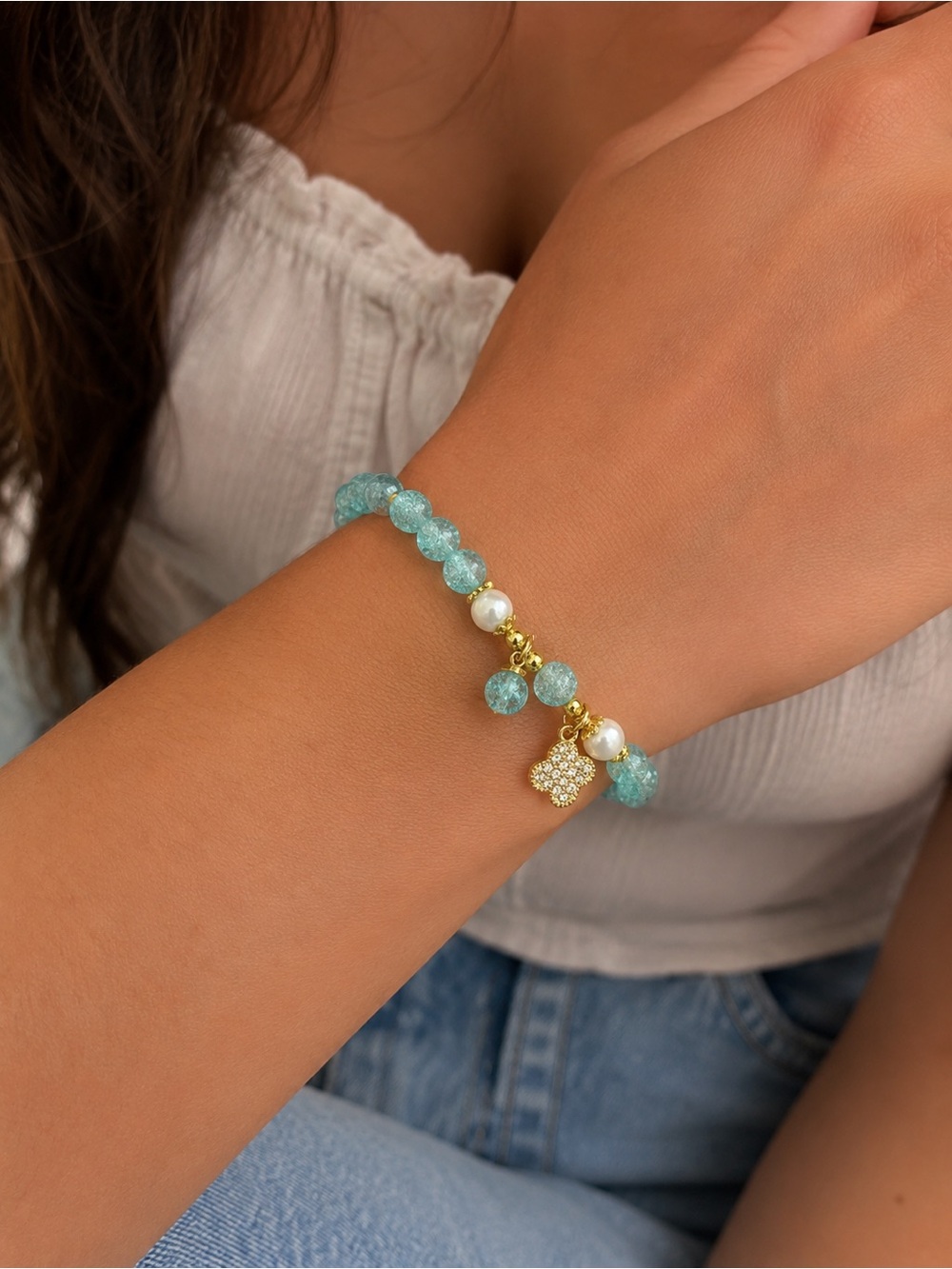 Blue beaded bracelet with clover charm